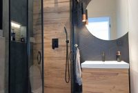 bathroom with walk-in shower with a glass door and a toilet