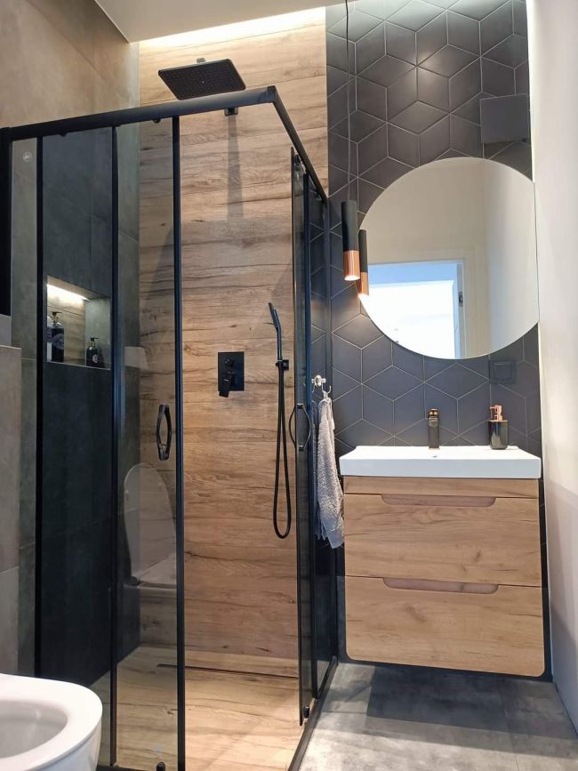 bathroom with walk-in shower with a glass door and a toilet